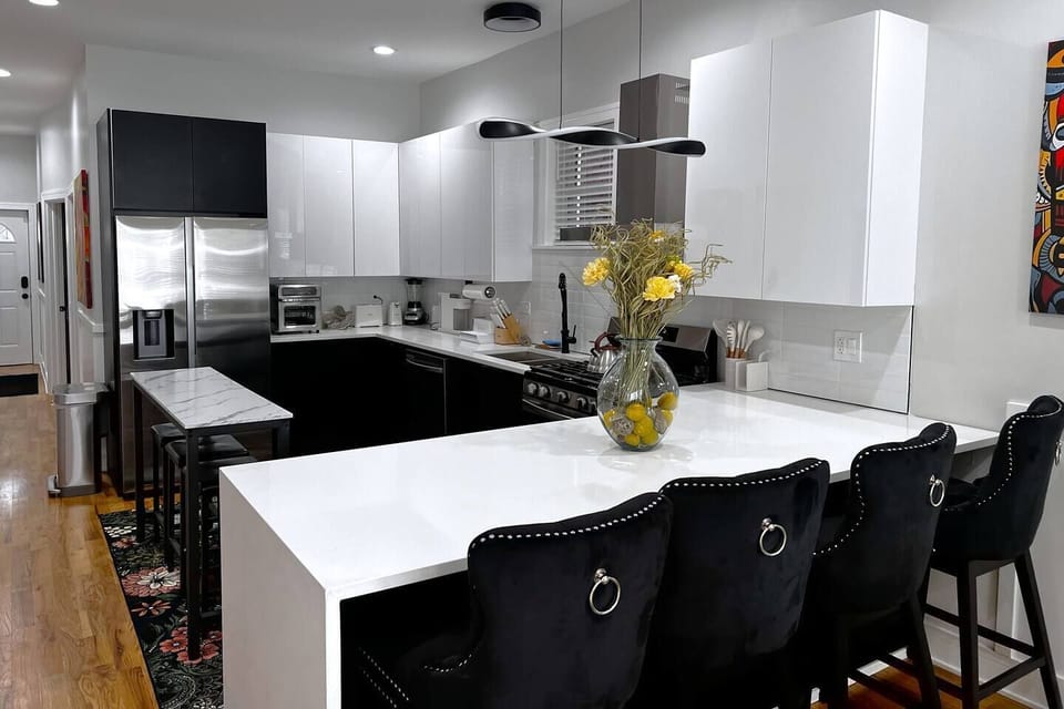 Oversized waterfall open space dining counter with plush oversized swivel dining chairs.