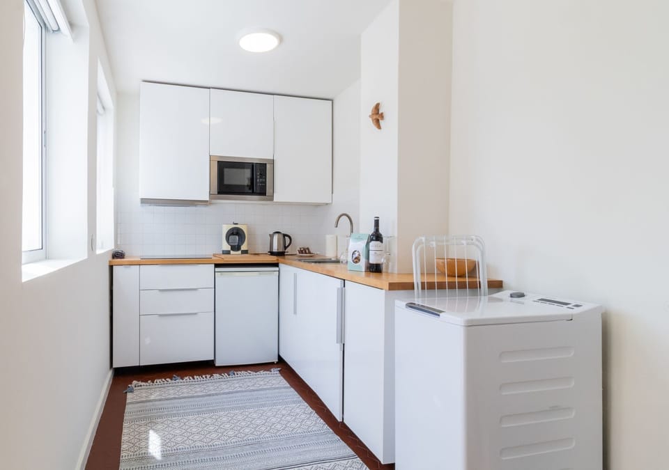 The kitchen has everything you need. including a microwave, kettle, and washing machine, ideal for longer stays.