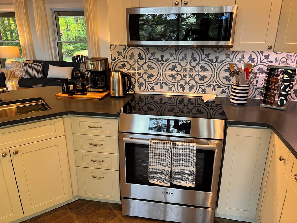 New induction stove and oven with a large microwave. Spices provided.