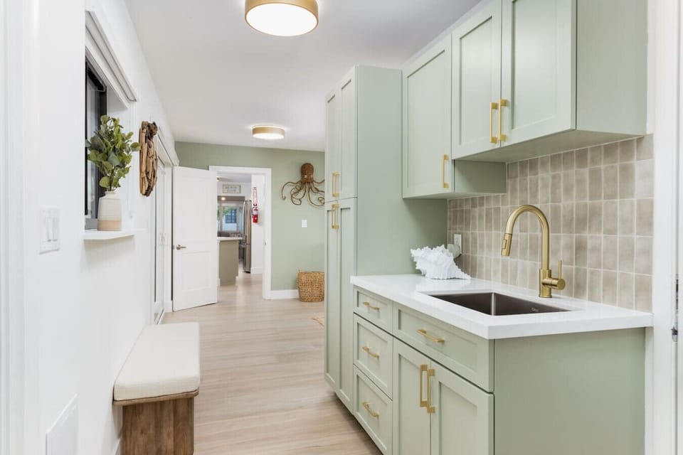 Stylish kitchenette with matching coastal design elements—ideal for storing drinks and light bites while staying close to the pool or game room.
