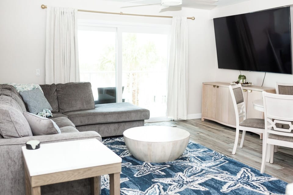 Living area with smart TV and balcony access