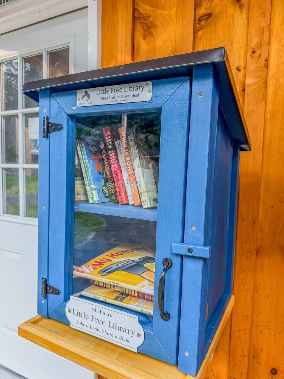 Charming outdoor Little Free Library adds a cozy, welcoming touch