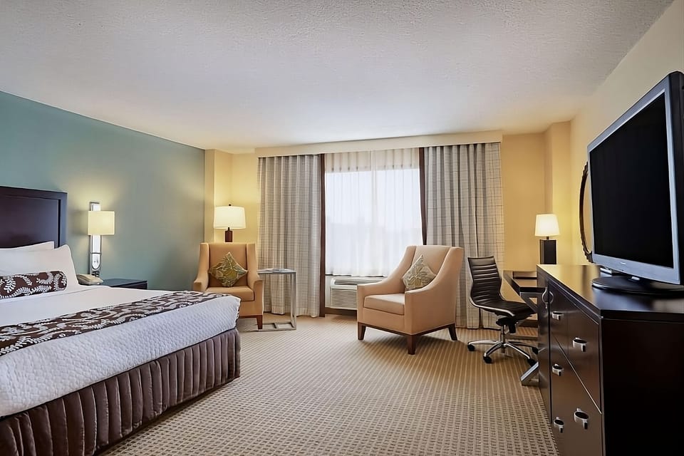 Settle in with lounge seating, soft light, and work desk.