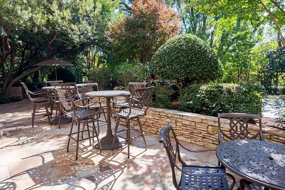 Unwind outdoors under dappled sunlight with garden-side seating.