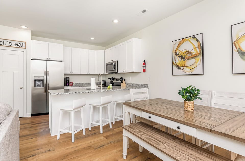 The kitchen and dining areas are spacious enough for everyone to settle in and enjoy a meal. There is seating for 4 at each kitchen island and seating for 6 at each dining room table.