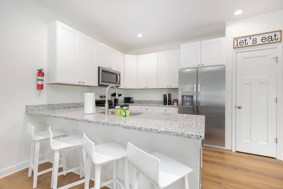 The kitchen and dining areas are spacious enough for everyone to settle in and enjoy a meal. There is seating for 4 at each kitchen island and seating for 6 at each dining room table.