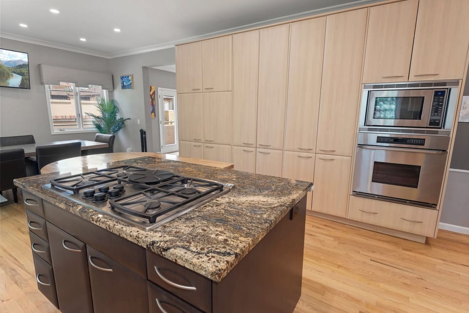 Cook with ease using sleek, modern appliances in a clean, well-equipped kitchen.