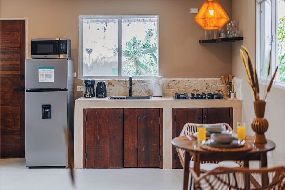Fully equipped kitchen with fridge, stovetop, and all the basics you need for convenient meal prep.

