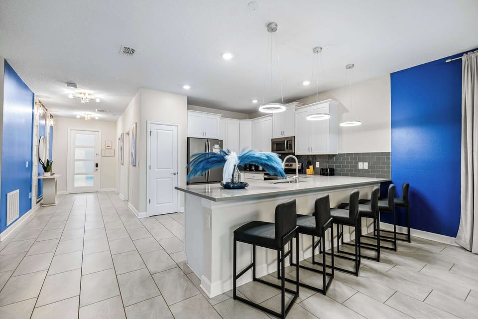 Modern open kitchen with island seating and fully equipped for your stay.