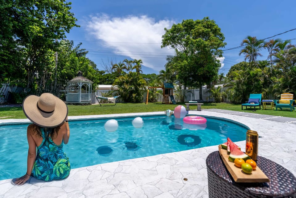 Backyard paradise awaits! Dive into the heated pool, soak in the hot tub, or challenge friends to life-size chess. Kids will love the playset, hammock swings, and soccer net, while you BBQ under the gazebo. Your private resort-style escape is here!