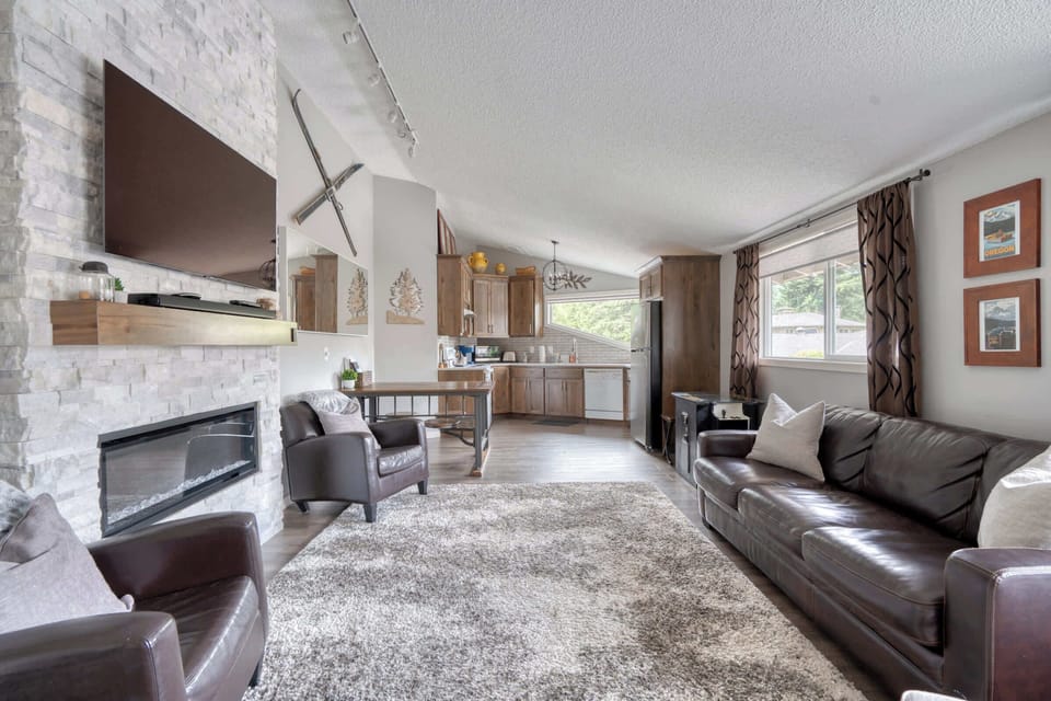 Living room with fireplace and kitchen view.