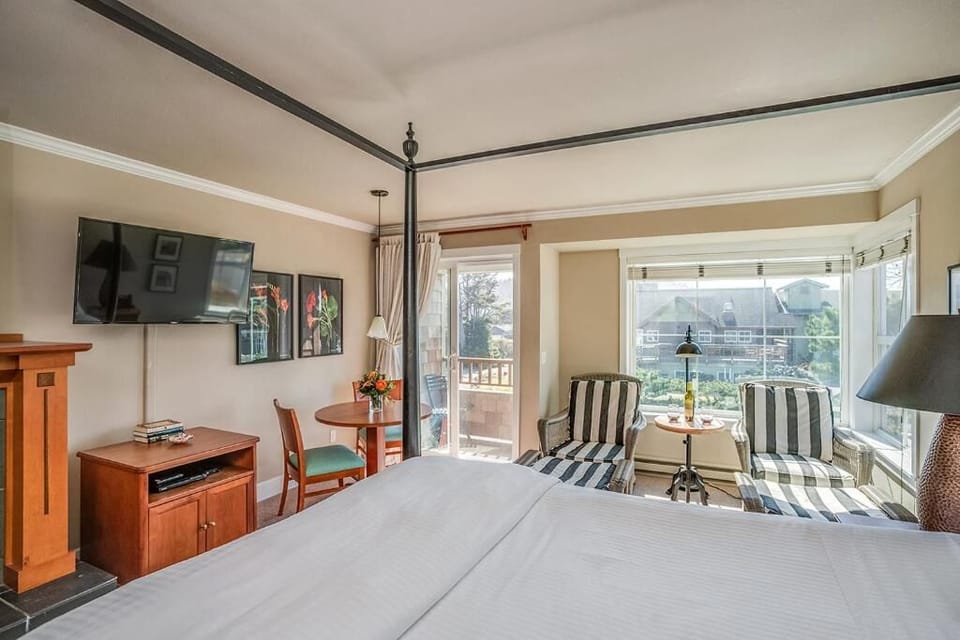 Sprawl out in a spacious bedroom with seating and balcony access.