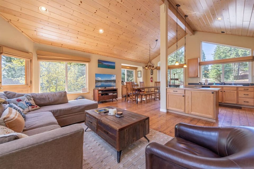 Open great room with vaulted ceilings, lots of natural light, river rock fireplace, large flat screen SmartTV.