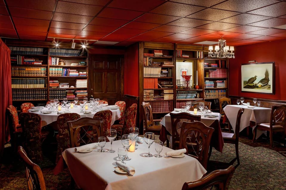Gather over dinner in a cozy, book-lined dining room.