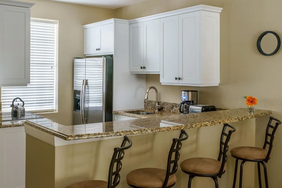 Gather for snacks at the granite bar, fully stocked kitchen.
