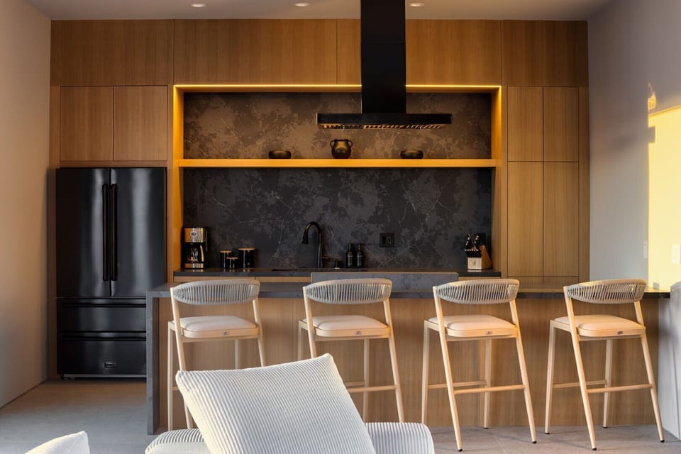 Kitchen island, large fridge and breakfast bar.