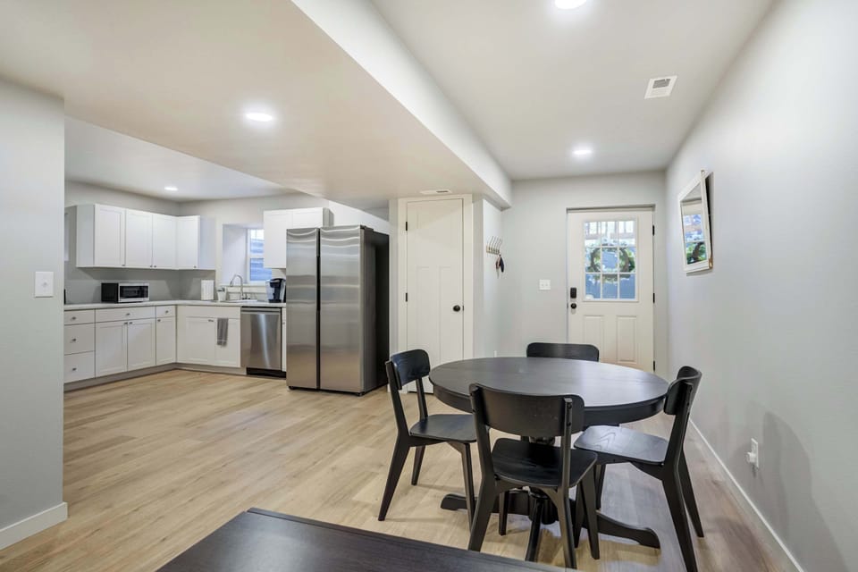 Enjoy home-cooked meals or takeout favorites around this modern dining table, perfectly placed between the kitchen and patio access for convenient, cozy gatherings..
