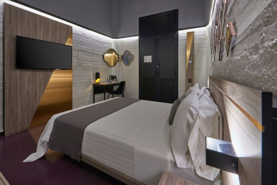 Unwind in a sleek room with soft lighting and TV.