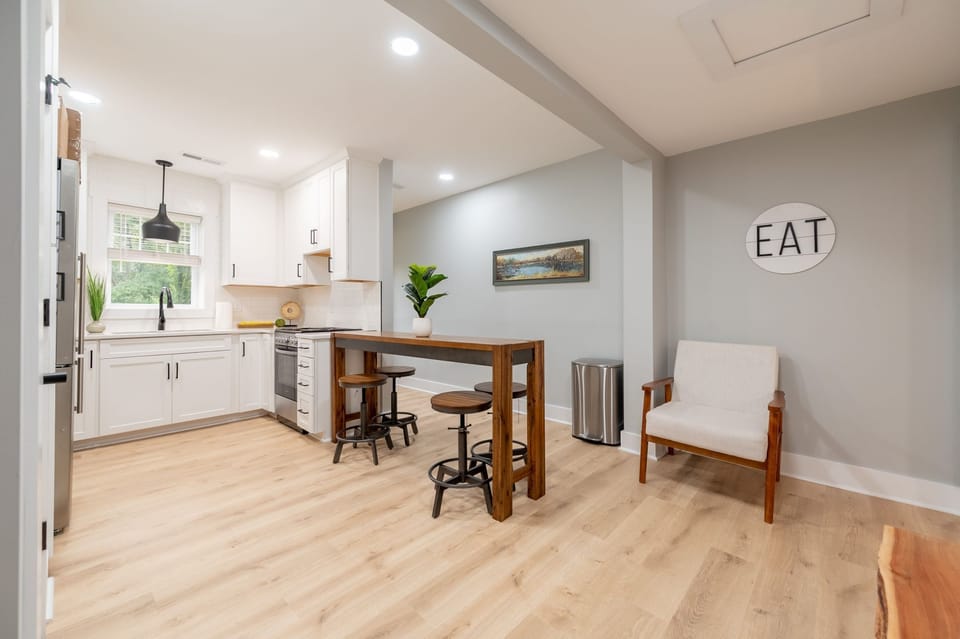 Open-concept kitchen and dining area with warm lighting and a cozy atmosphere.