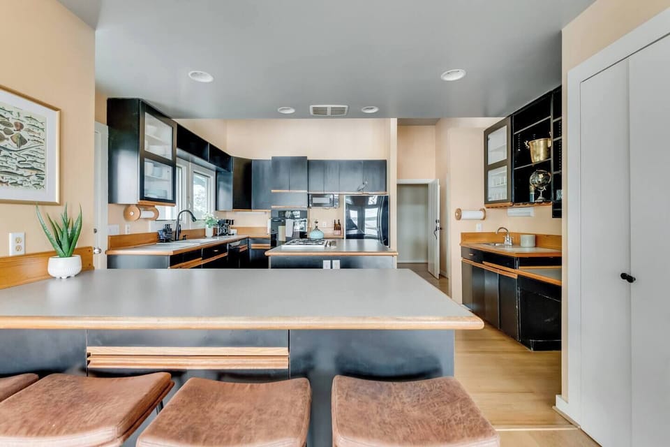 Fully Stocked Kitchen: Modern finishes and stylish seating make meal prep a delight. Enjoy the views!