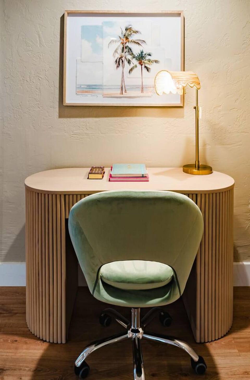 A charming workspace with a serene coastal touch. This cozy desk area, complete with a stylish lamp and a soft green chair, provides a peaceful spot to unwind or get productive in your own private retreat.