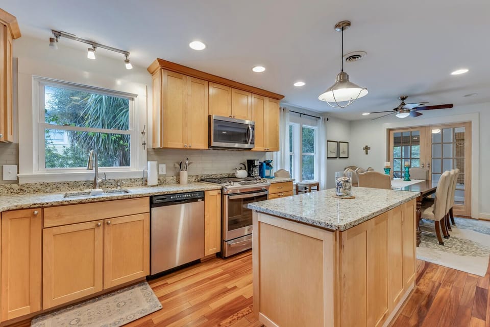 Your spacious chef's kitchen features granite countertops, stainless appliances, and a breakfast island perfect for morning coffee and meal prep.