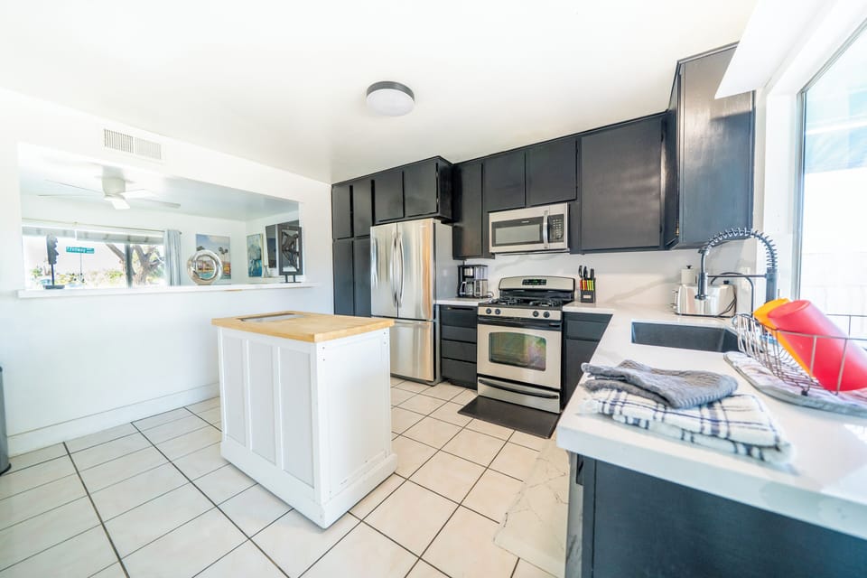 Sleek kitchen with island and stainless steel—cook, dine, and entertain!