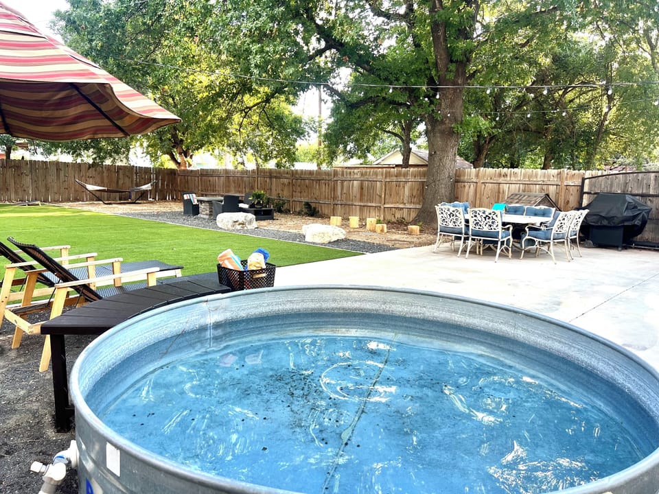 Enjoy stock tank pool, lounge chairs, solar lights, and grill.