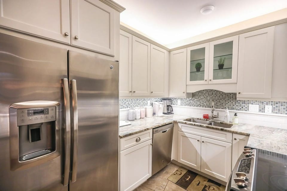 Modern kitchen with stainless steel appliances and granite counters.