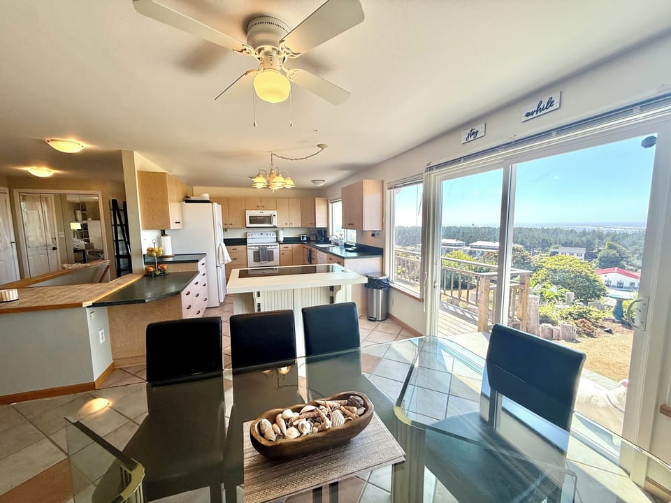 Dining Room and Kitchen with Sliding Glass Door to Backyard and Hot Tub