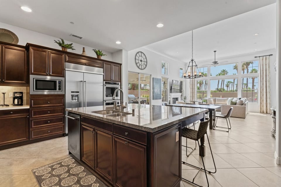 Bright kitchen w/ large island, bar seating & windows overlooking the backyard