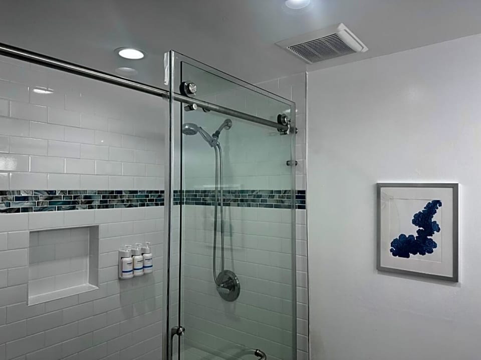 Rinse off in a sleek glass shower with spa-like tiles.