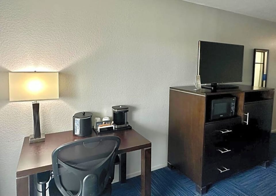 Recharge and work smoothly with desk, coffee, and TV.