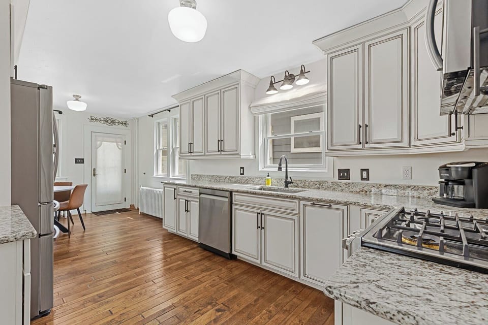 Bright and Modern Kitchen with Dining Area View. Enjoy the perfect blend of style and function in this bright, modern kitchen.