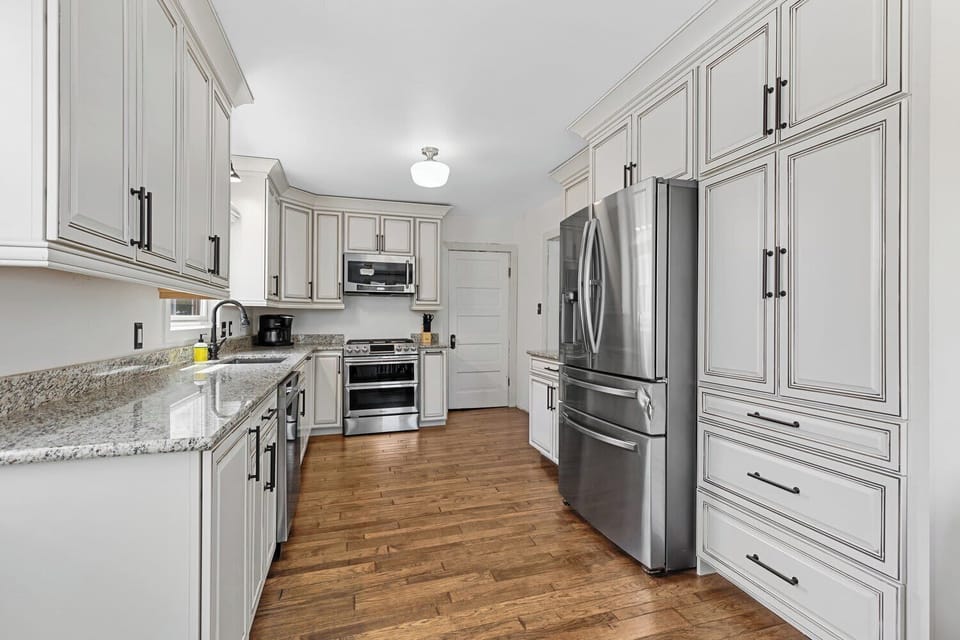 Cook like a chef in this fully equipped kitchen featuring sleek stainless steel appliances, granite countertops, and custom cabinetry.