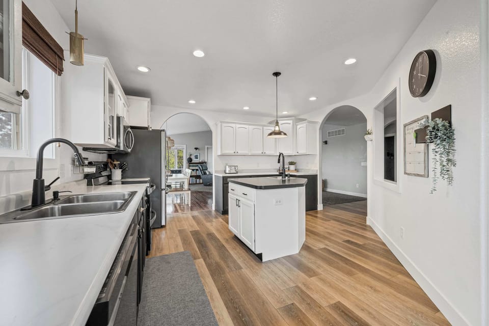 Polished kitchen design w/ bright lighting and smooth surfaces