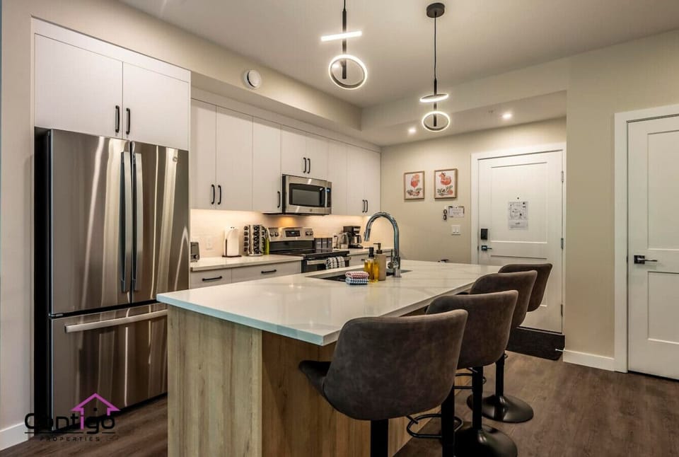 Fully equipped kitchen with modern appliances, island seating, and everything you need for home-cooked meals.