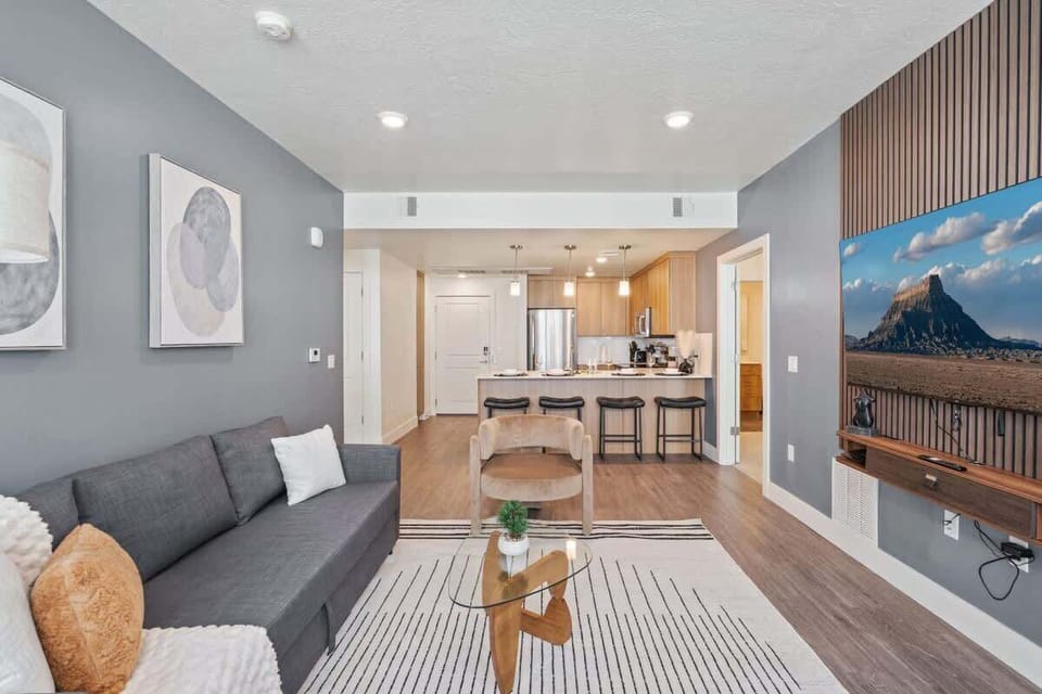 Natural light and cozy vibes – our living room features a TV and beautiful, large windows.