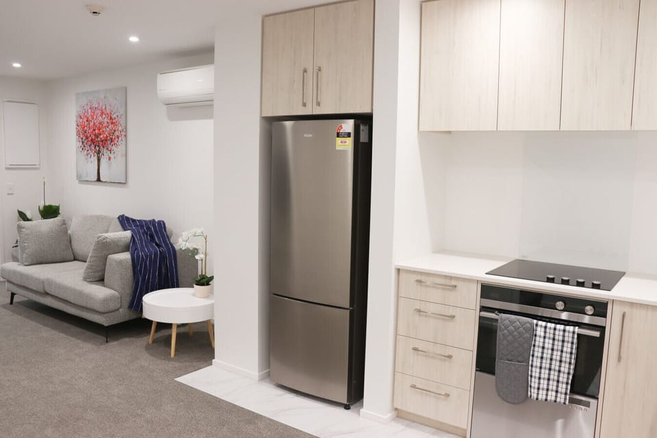 Spacious living area with a cozy sofa, stylish decor, and plenty of natural light—ideal for relaxing and unwinding.