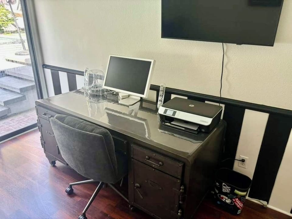 Private workspace in the downstairs bedroom.
