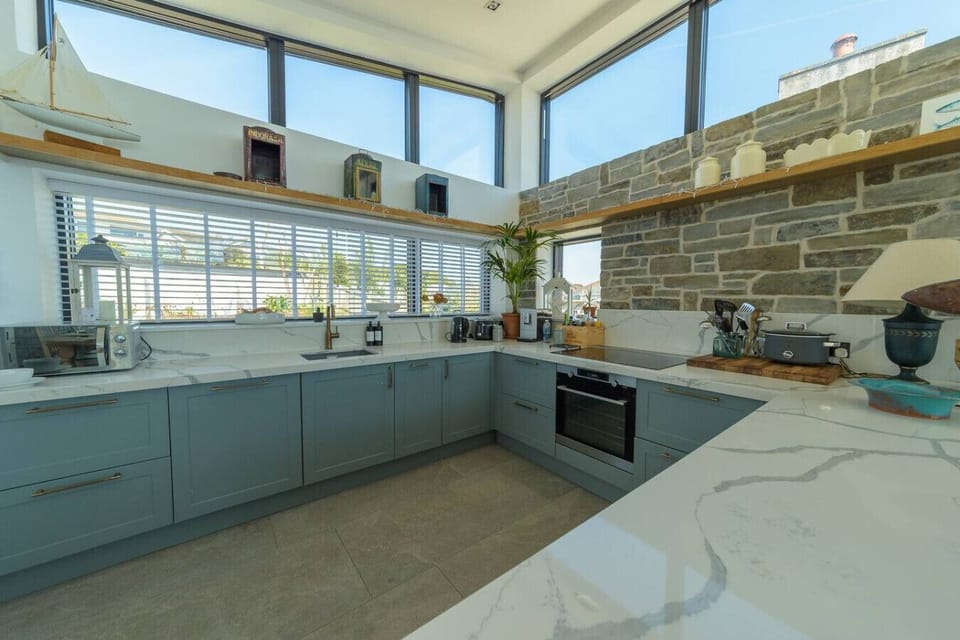 Open-plan kitchen with modern appliances and island seating.