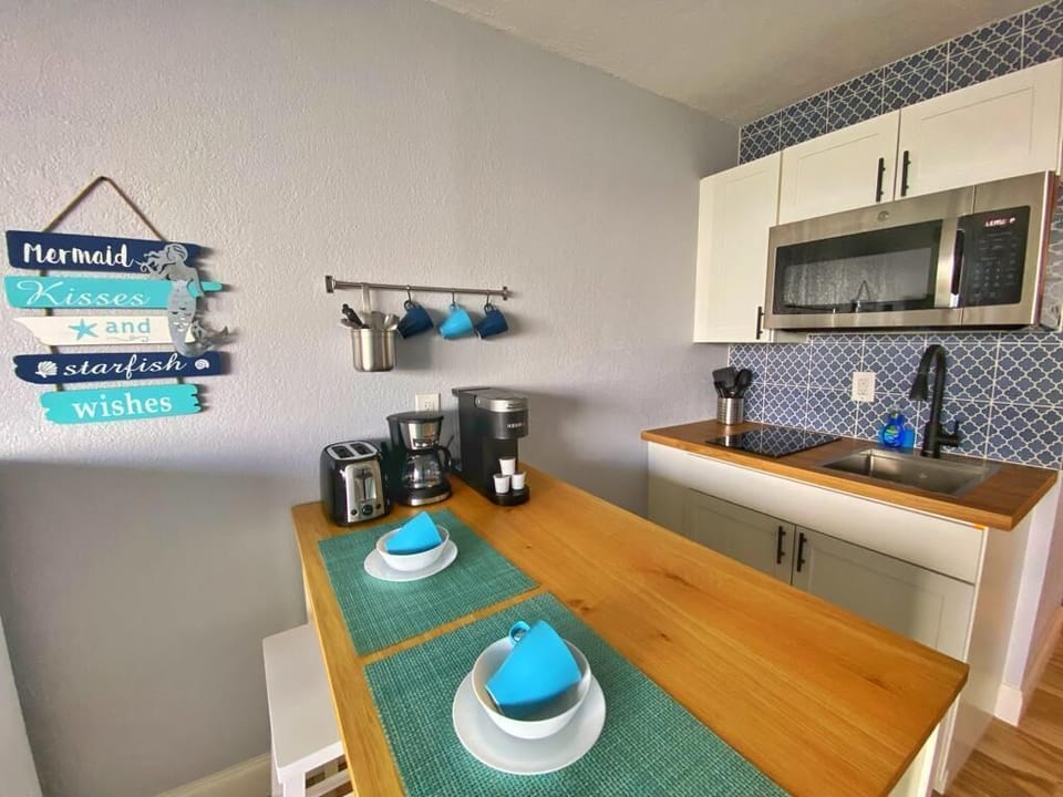 New kitchen with cooktop, microwave, fridge, toaster & Keurig
