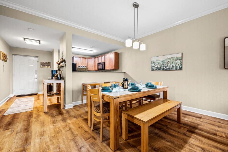 Spacious dining area with a table set for six with additional bar seating for two