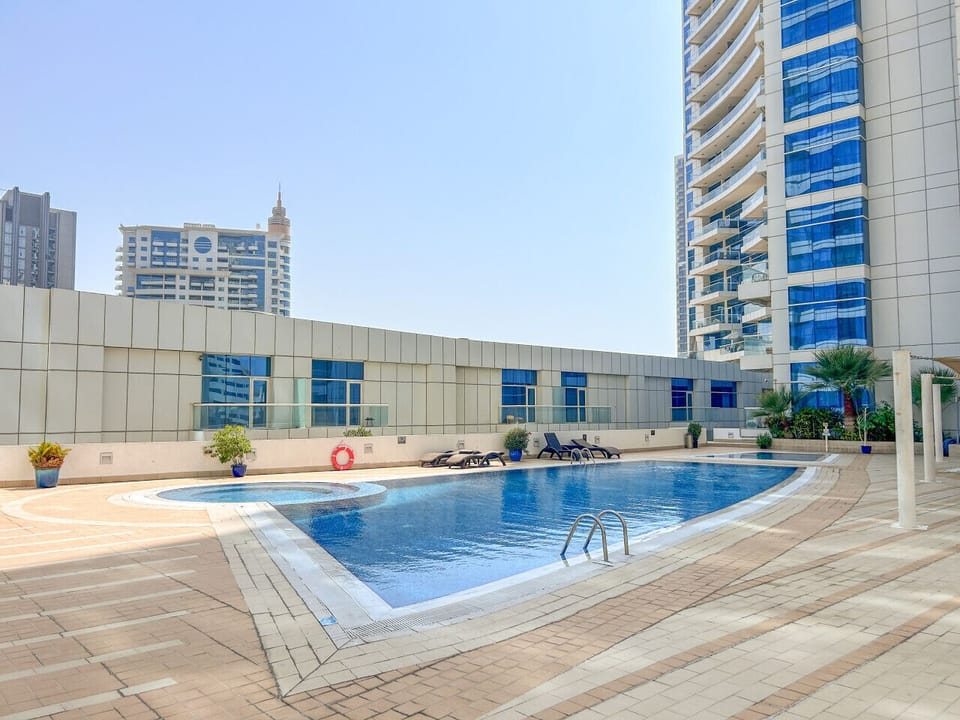 Sunny poolside with lounge chairs perfect for a relaxing swim or sun soak.