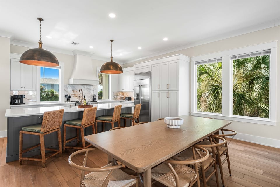 Your spacious kitchen flows seamlessly into the dining area, where warm wood tones and tropical views create the perfect space for memorable meals.