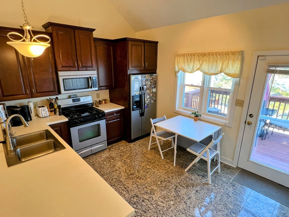 Full kitchen with kitchen table and bar