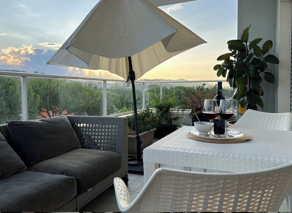 Balcony with a table and umbrella