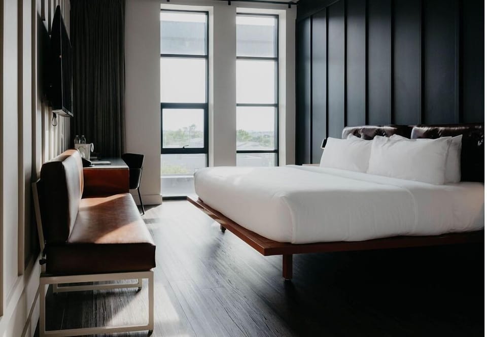 Wake up to sunlight in a sleek, modern king room.