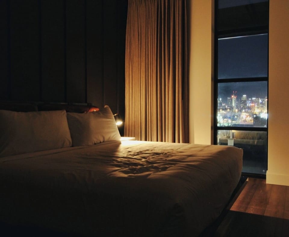 Drift off to city lights from a softly lit room.