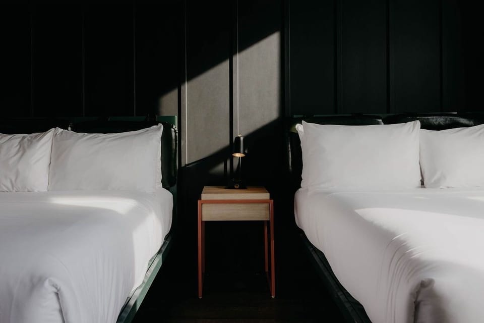 Sink into crisp linens between twin beds and soft light.